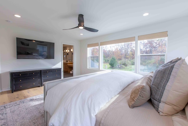 bedroom with recessed lighting, ceiling fan, ensuite bathroom, and light wood finished floors