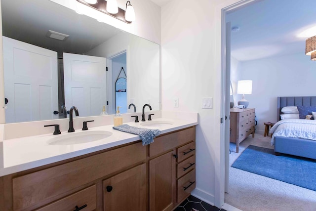 ensuite bathroom featuring ensuite bath, double vanity, and a sink