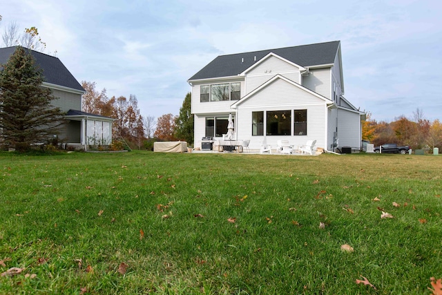 rear view of property featuring a lawn