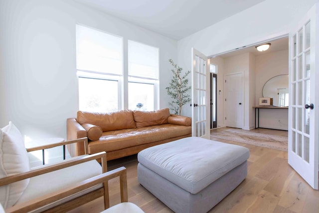 living room with light wood-style flooring and french doors