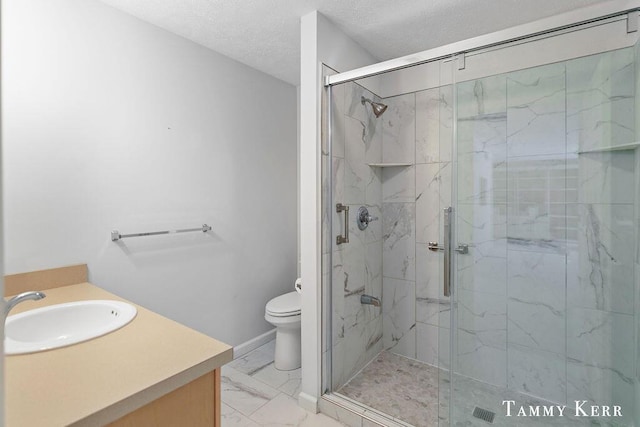 full bathroom with vanity, a marble finish shower, a textured ceiling, toilet, and marble finish floor