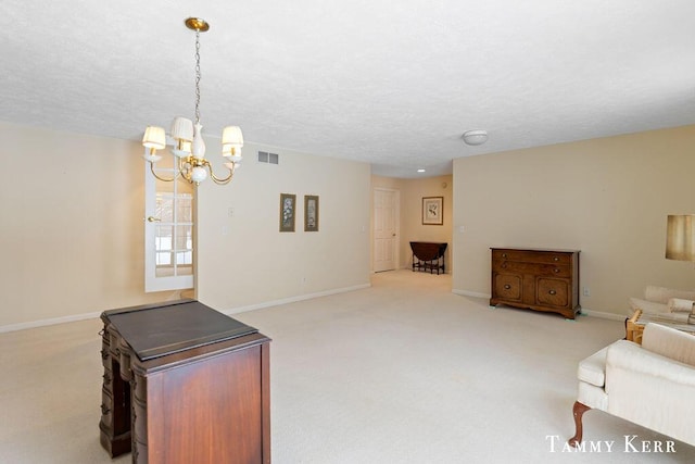 carpeted living room with visible vents, baseboards, and a textured ceiling