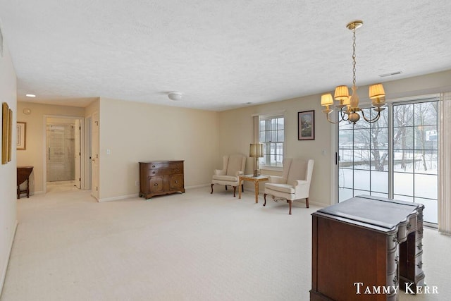 sitting room with carpet, baseboards, visible vents, a textured ceiling, and a notable chandelier