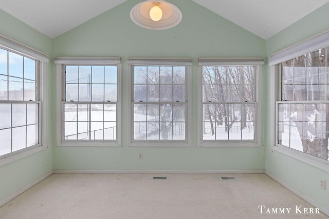 unfurnished sunroom featuring lofted ceiling and visible vents