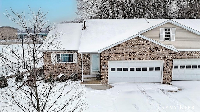 view of front facade with brick siding and an attached garage