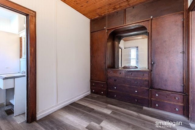 unfurnished bedroom with wood ceiling and wood finished floors