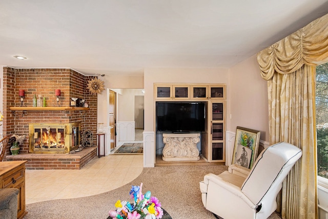 carpeted living room featuring tile patterned floors and a brick fireplace