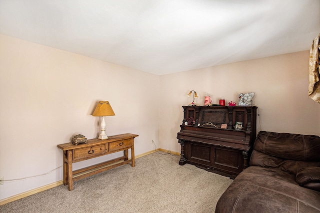 sitting room featuring baseboards and carpet flooring