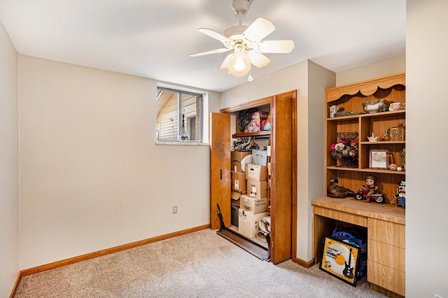 bedroom featuring light colored carpet, baseboards, a closet, and ceiling fan