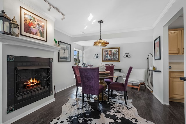 dining space with dark wood-type flooring, baseboards, and ornamental molding