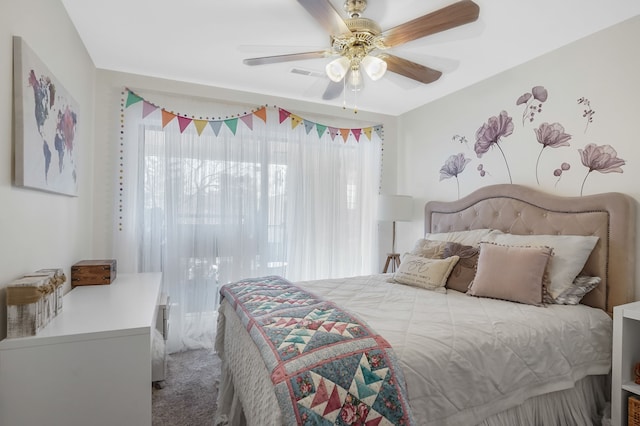 bedroom with a ceiling fan and carpet