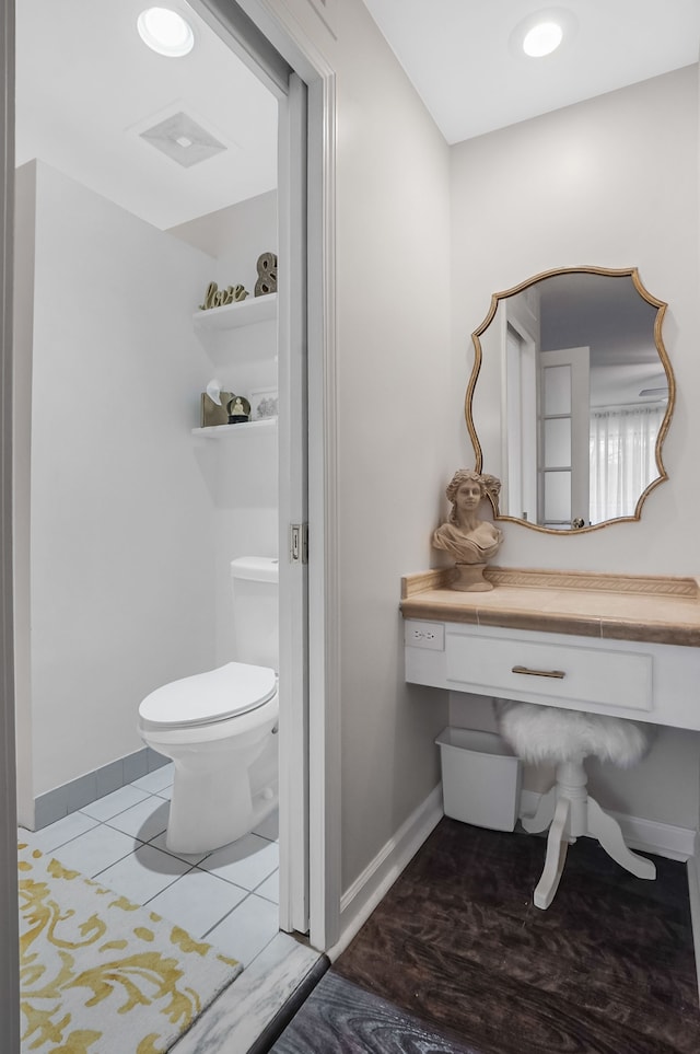 bathroom featuring visible vents, baseboards, toilet, and tile patterned flooring