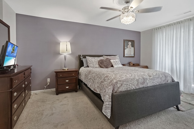 bedroom featuring visible vents, light carpet, baseboards, and ceiling fan