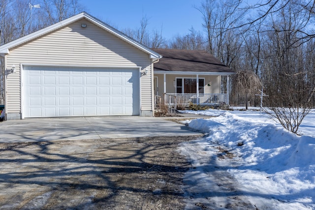 single story home featuring a porch, driveway, and a garage