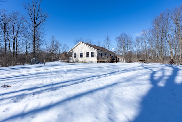 snow covered property featuring a deck