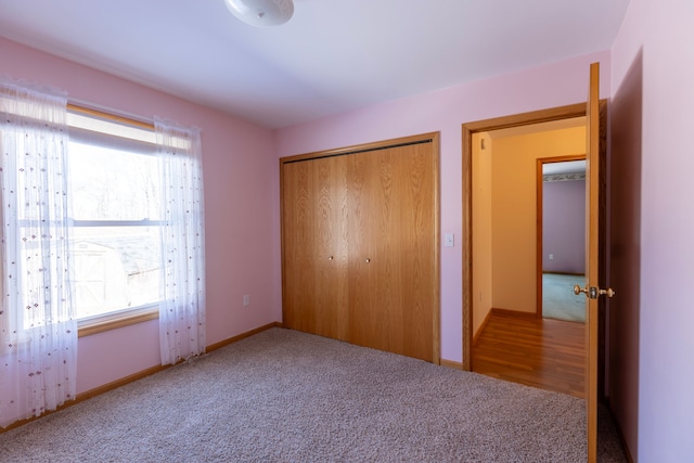 unfurnished bedroom with carpet flooring and a closet