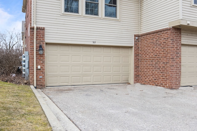 garage with aphalt driveway