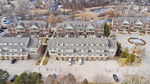 drone / aerial view featuring a residential view and a water view