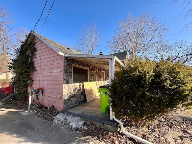 view of side of home with stone siding