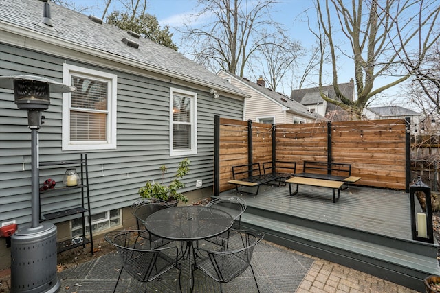 deck with outdoor dining space and fence