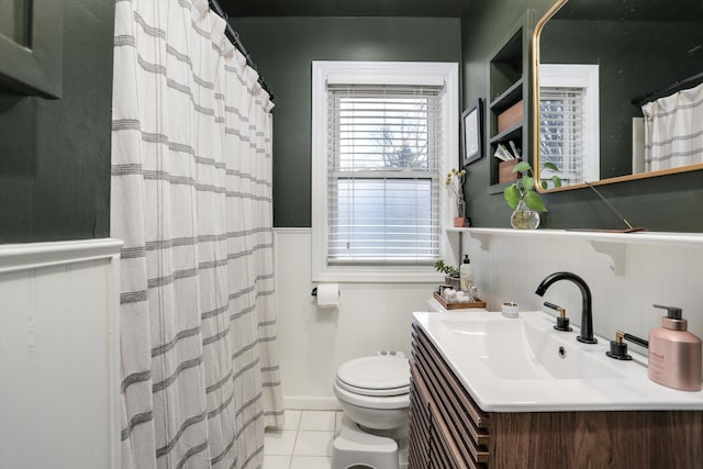 bathroom featuring tile patterned flooring, curtained shower, toilet, wainscoting, and vanity