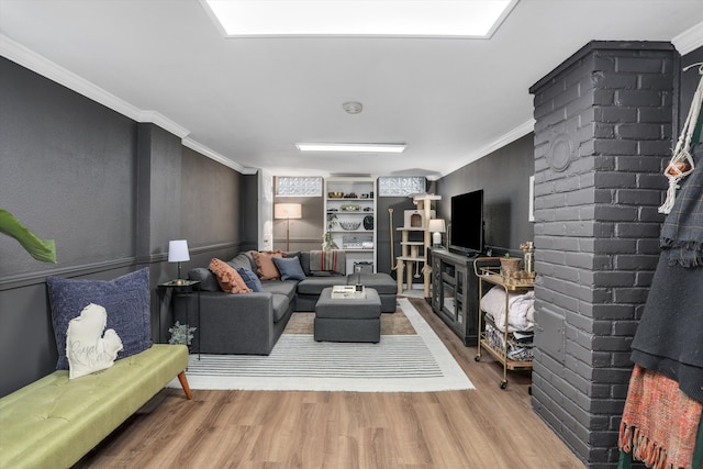 living area featuring crown molding and wood finished floors