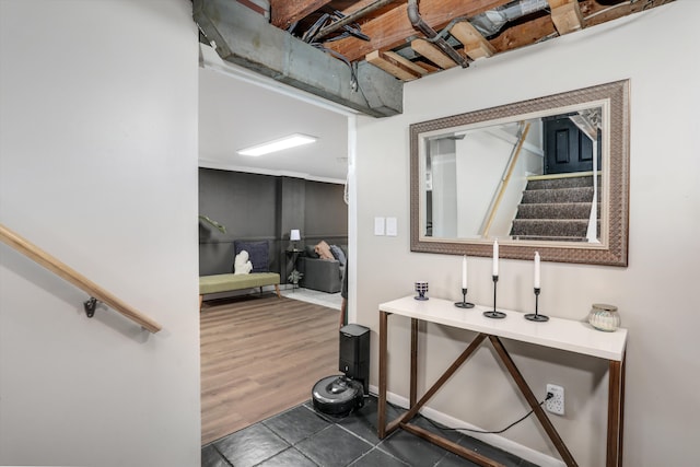 interior space with dark tile patterned floors and stairs