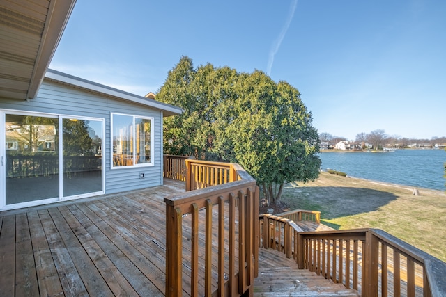 wooden terrace featuring a yard and a water view