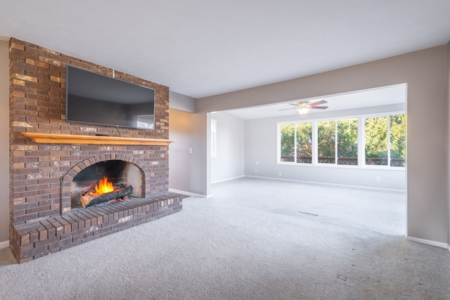 unfurnished living room with carpet flooring, baseboards, and a fireplace