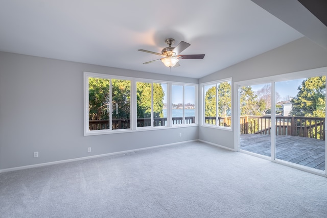 unfurnished sunroom featuring visible vents and a ceiling fan