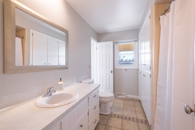 full bathroom featuring visible vents, toilet, tile patterned flooring, baseboards, and vanity