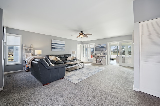 carpeted living area with visible vents, french doors, baseboards, and ceiling fan