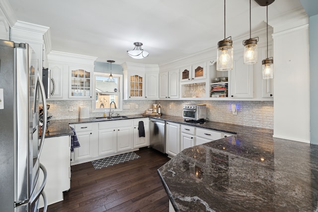 kitchen with a sink, appliances with stainless steel finishes, dark wood-style floors, and white cabinetry