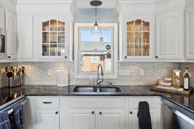 kitchen with a sink, decorative light fixtures, stainless steel dishwasher, white cabinets, and glass insert cabinets