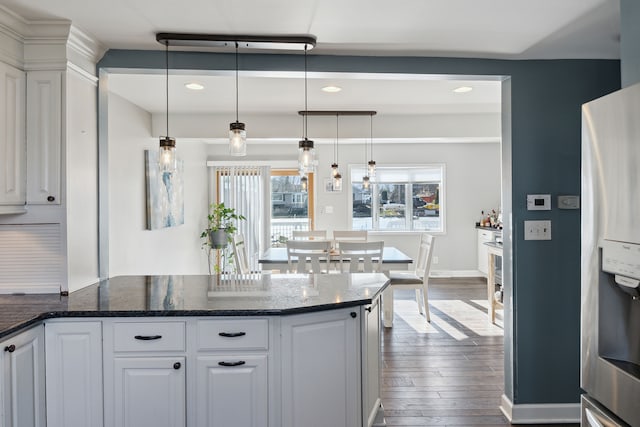 kitchen with dark wood finished floors, a peninsula, white cabinetry, and stainless steel refrigerator with ice dispenser