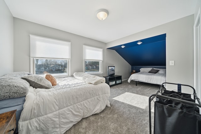 bedroom featuring baseboards, carpet flooring, and vaulted ceiling