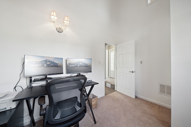 office space featuring baseboards, visible vents, and carpet floors