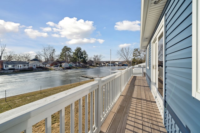 balcony featuring a residential view and a water view