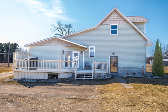 back of house featuring a yard and a deck