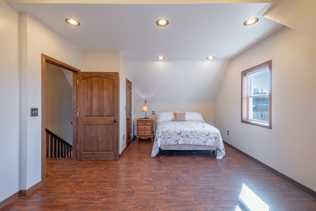 bedroom featuring lofted ceiling, recessed lighting, wood finished floors, and baseboards