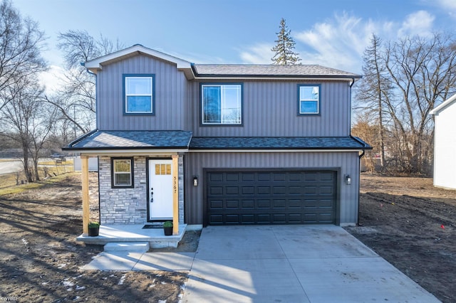 view of front of home with an attached garage, stone siding, driveway, and a shingled roof