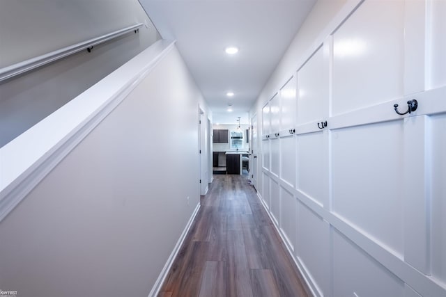 corridor featuring recessed lighting, baseboards, and dark wood-style flooring