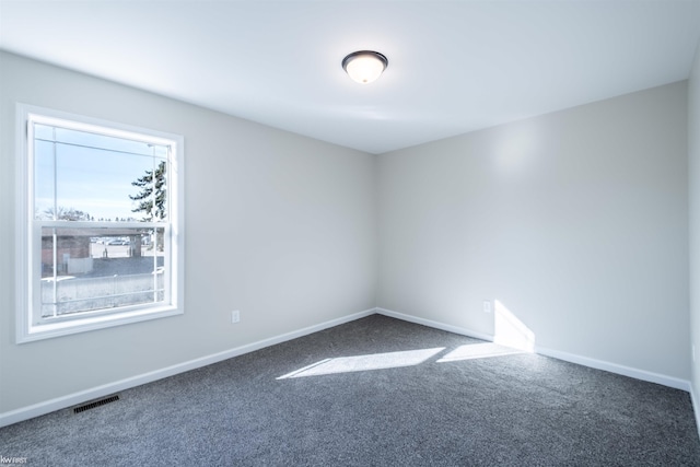 spare room featuring visible vents, baseboards, and carpet floors