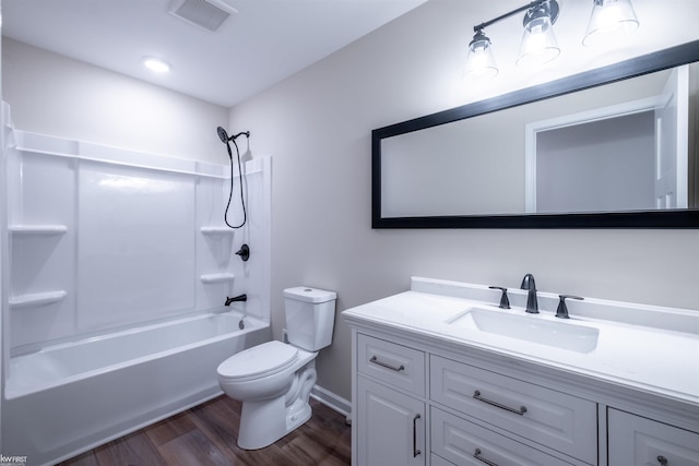 full bathroom featuring visible vents, toilet, bathing tub / shower combination, wood finished floors, and vanity