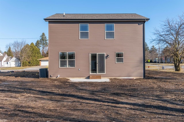 rear view of house featuring central AC unit and entry steps