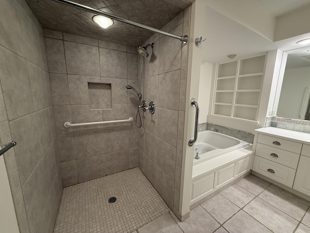 bathroom featuring tile patterned flooring, tiled shower, vanity, and a garden tub