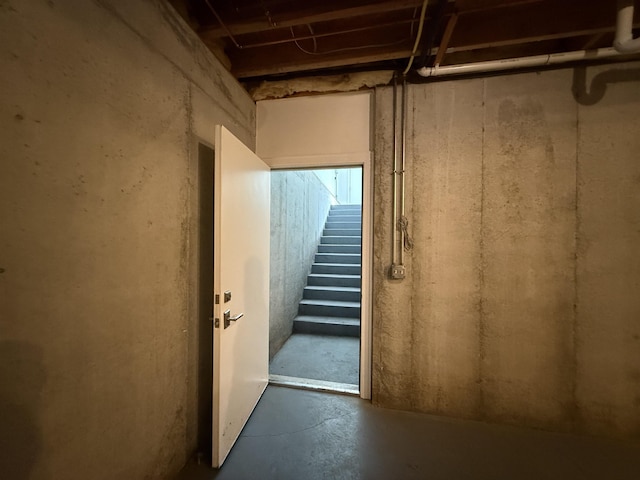 unfinished below grade area featuring stairway