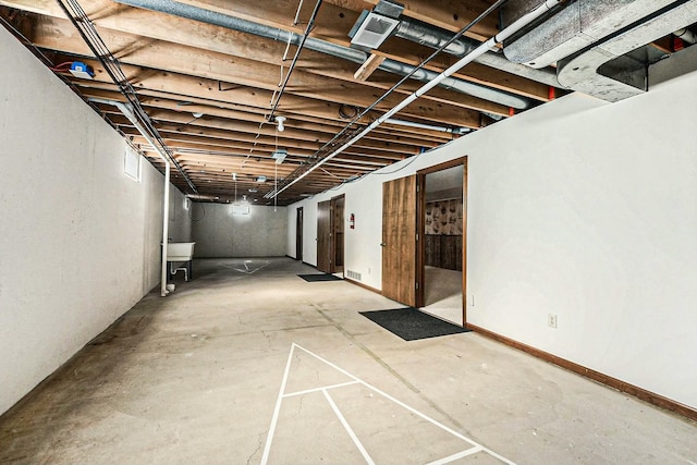 unfinished basement featuring visible vents and a sink