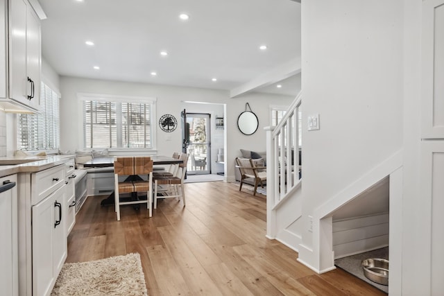 interior space with recessed lighting, white cabinets, light countertops, and light wood finished floors