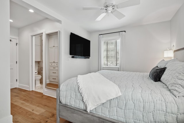 bedroom with recessed lighting, ensuite bath, ceiling fan, and wood finished floors